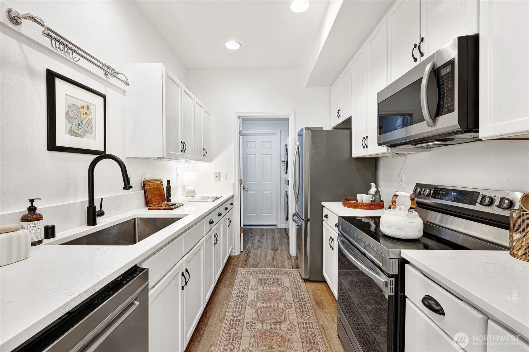 8828 238th Street Southwest, Unit B4 Edmonds, WA 98026 - Photo 14 of 37 a kitchen with stainless steel appliances a stove microwave and sink