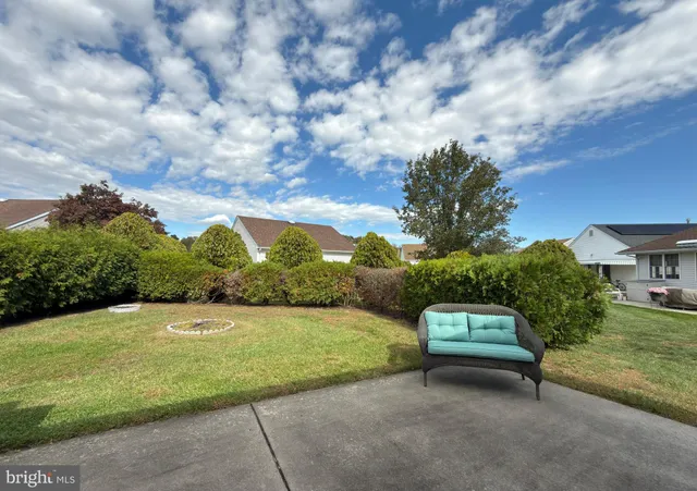 a view of a garden with a bench in a garden