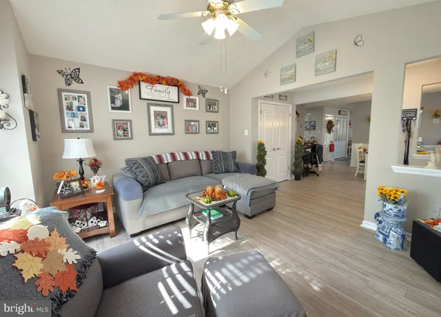 a living room with furniture and a chandelier