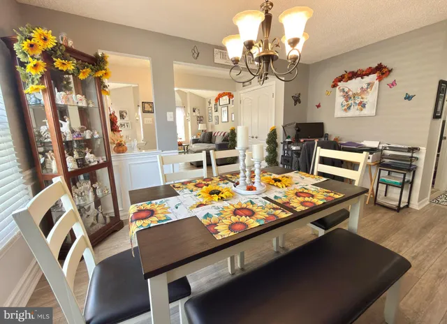 a view of a dining room with furniture and a chandelier