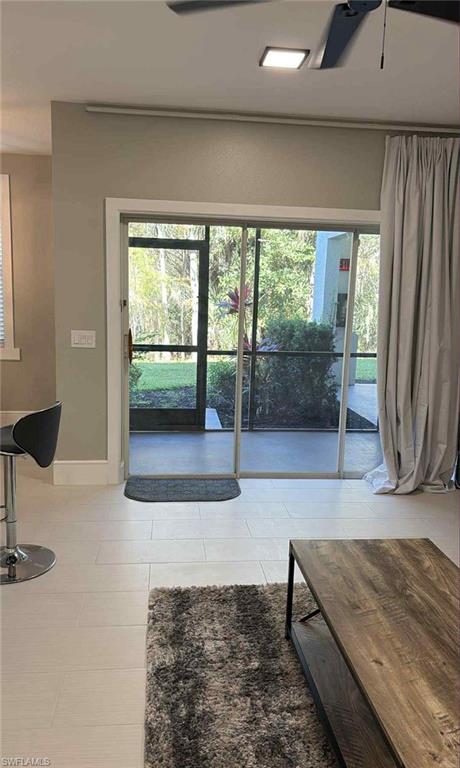 7940 Preserve Circle, Unit 914 Naples, FL 34119 - Photo 12 of 16 a living room with a couch and large window