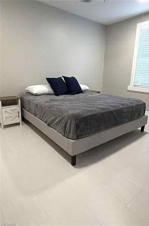 a bedroom with a bed and window