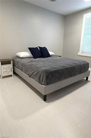 a bedroom with a bed and window