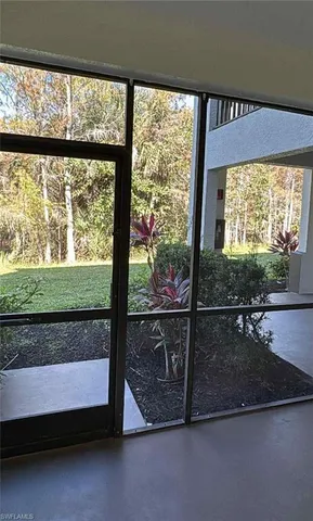 a view of a room with wooden floor and a floor to ceiling window