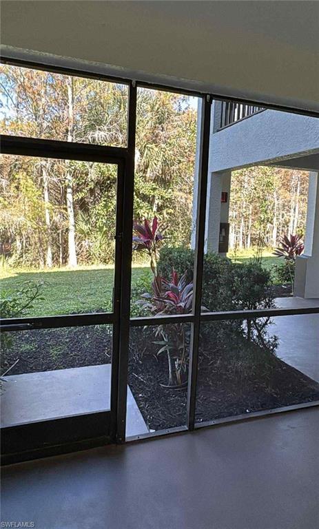 7940 Preserve Circle, Unit 914 Naples, FL 34119 - Photo 15 of 16 a view of a room with wooden floor and a floor to ceiling window