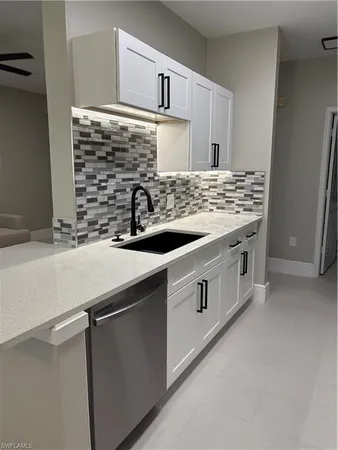 a kitchen with a sink and a stove