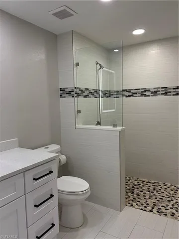 a bathroom with a toilet a sink and shower