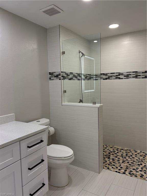 7940 Preserve Circle, Unit 914 Naples, FL 34119 - Photo 7 of 16 a bathroom with a toilet a sink and shower
