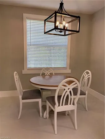 a view of a dining room with furniture and window