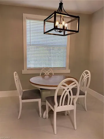 a view of a dining room with furniture and window