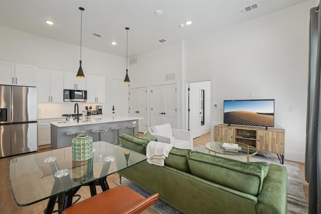 6418 Maple Avenue, Unit 312 Dallas, TX 75235 - Photo 6 of 16 a living room with furniture a refrigerator and kitchen view