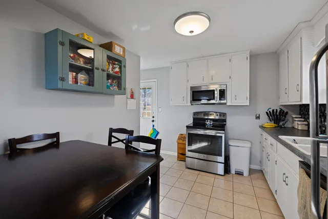 a kitchen with a sink appliances and cabinets