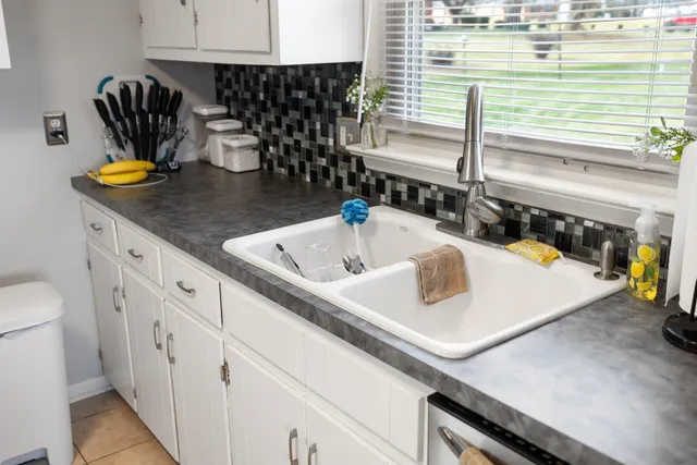 a kitchen with a sink and a stove top oven