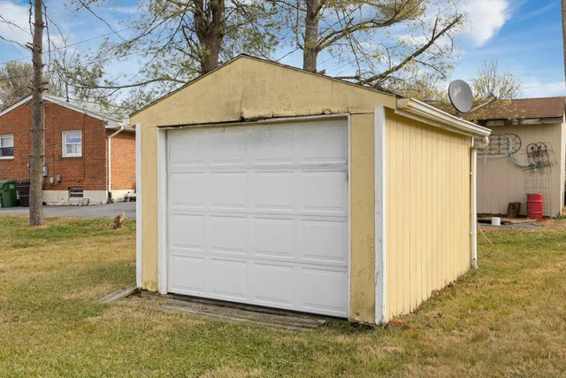 a view of a big house with a big yard and large tree