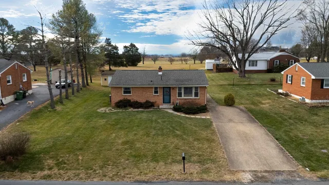 a aerial view of a house with a yard basket ball court and outdoor seating