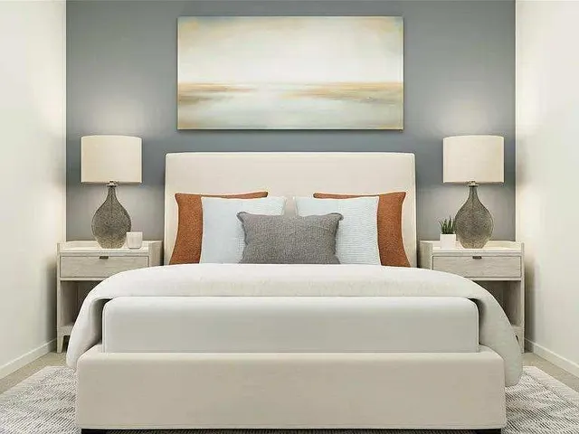 a bedroom with a bed and a potted plant