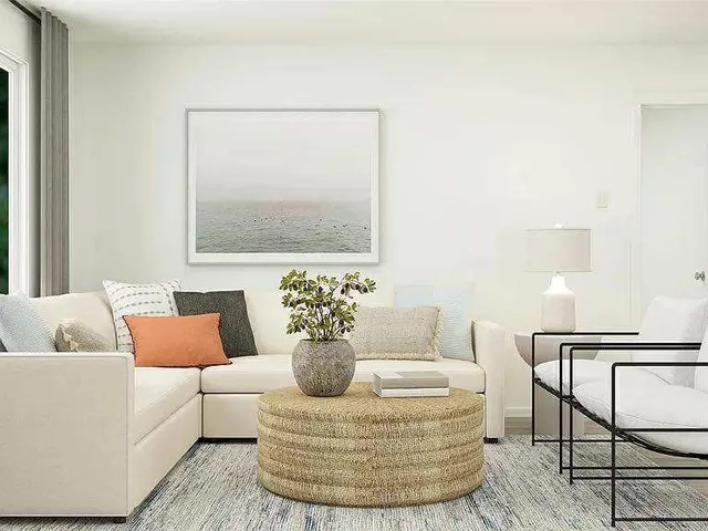 a living room with furniture and a potted plant