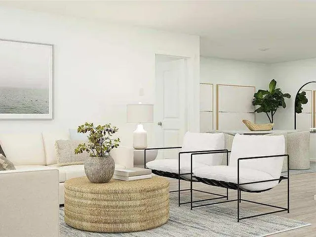 a living room with furniture and a potted plant