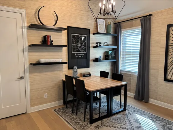 a bedroom with a bed a window and a chandelier