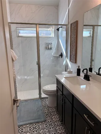 a bathroom with a sink a toilet and mirror