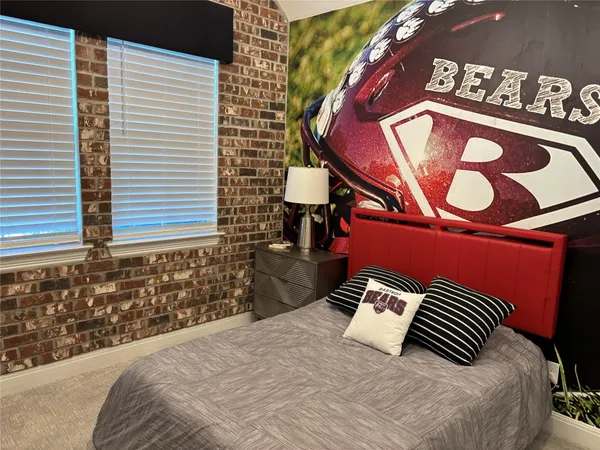 a bedroom with bed and a window