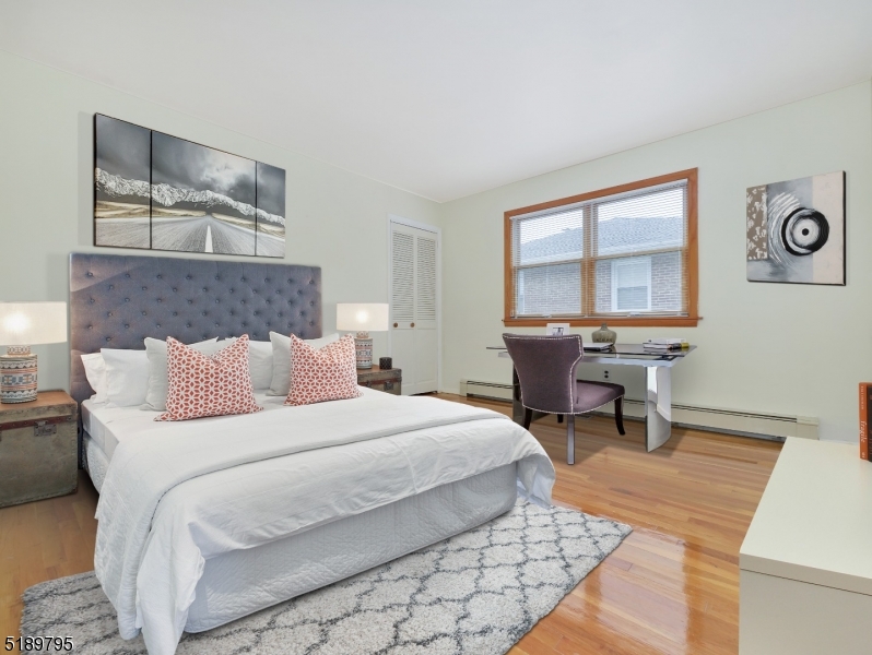 69 Rector Street Millburn, NJ 07041 - Photo 18 of 29 a bedroom with a bed a table and chair