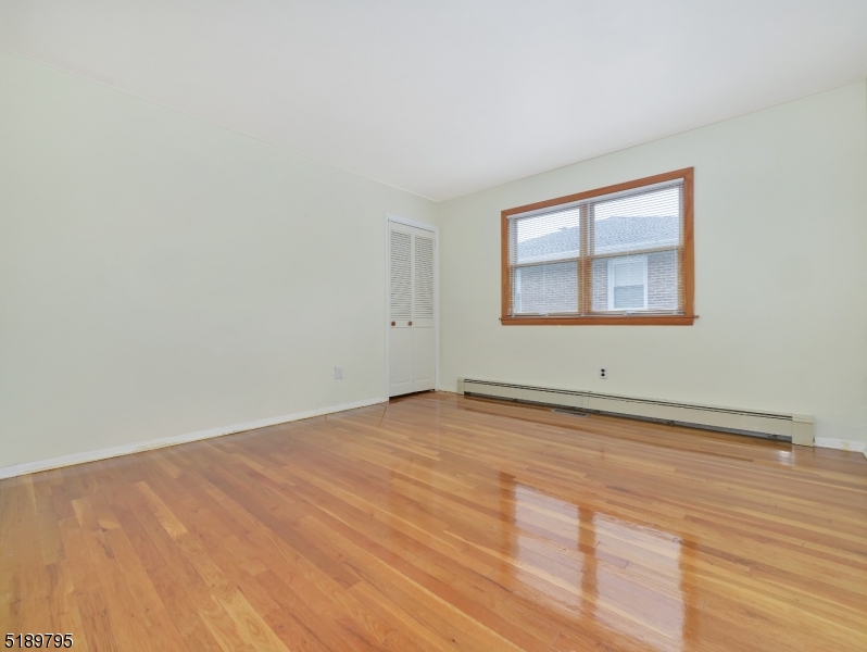 69 Rector Street Millburn, NJ 07041 - Photo 19 of 29 a view of empty room with wooden floor and fan
