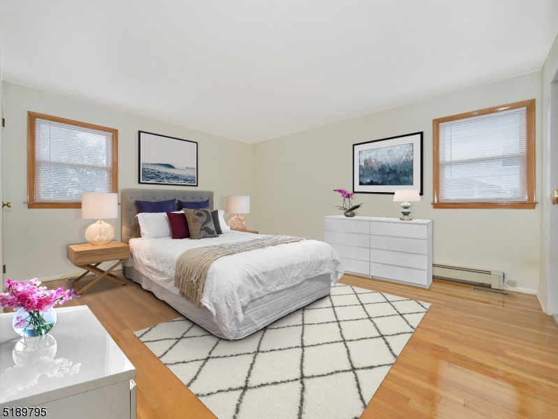 69 Rector Street Millburn, NJ 07041 - Photo 20 of 29 a bedroom with a bed and a flat screen tv