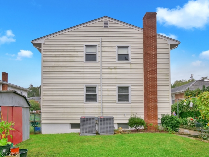 69 Rector Street Millburn, NJ 07041 - Photo 26 of 29 a view of a house with a yard and plants