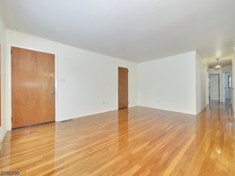 69 Rector Street Millburn, NJ 07041 - Photo 5 of 29 a view of an empty room with wooden floor