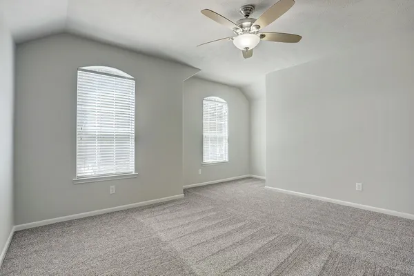 a view of a room with a ceiling fan and a window