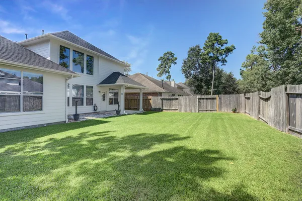 a front view of a house with a yard and trees