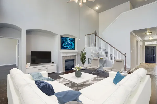 a living room with furniture a fireplace and a flat screen tv