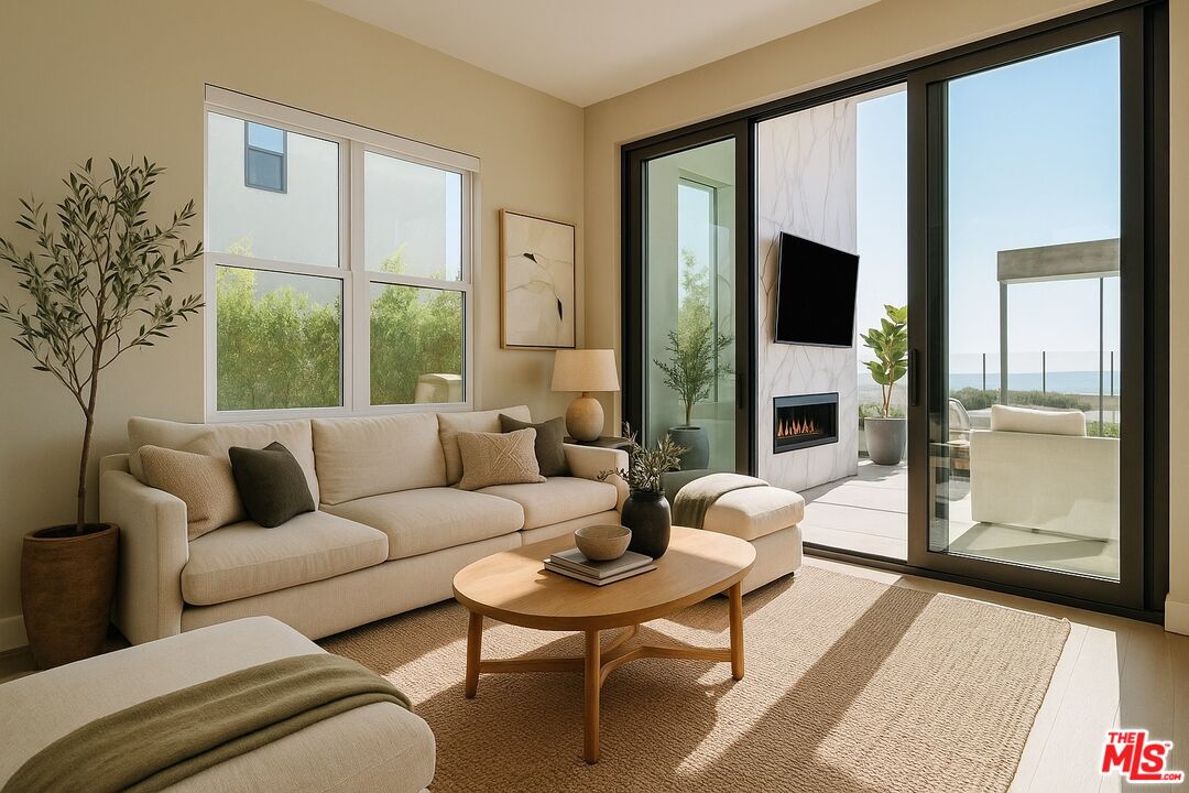 20306 Willoughby Lane Porter Ranch, CA 91326 - Photo 12 of 40 a living room with furniture a flat screen tv and a floor to ceiling window