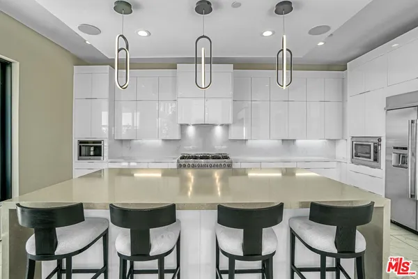 a kitchen with stainless steel appliances granite countertop a sink cabinets and stove