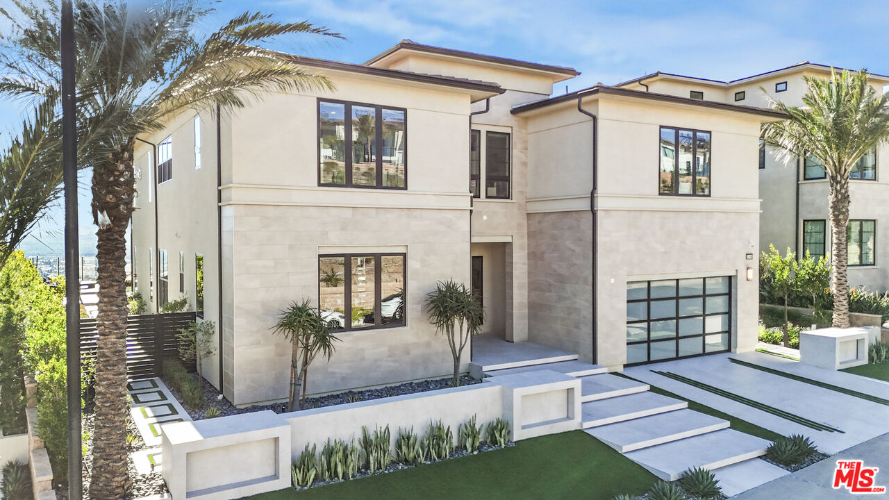 20306 Willoughby Lane Porter Ranch, CA 91326 - Photo 2 of 40 a front view of a house with a garden