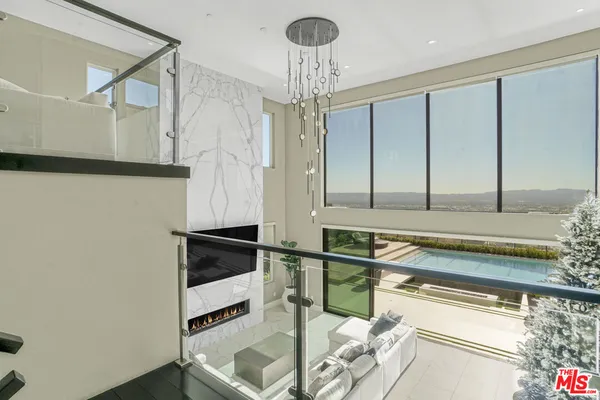 a living room with furniture with wooden floor and windows