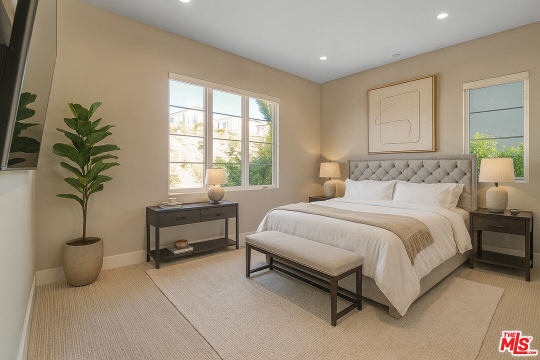 20306 Willoughby Lane Porter Ranch, CA 91326 - Photo 34 of 40 a bedroom with a bed and a potted plant