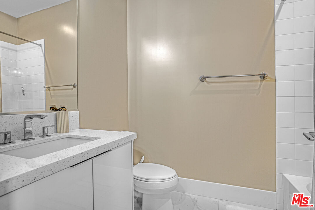 20306 Willoughby Lane Porter Ranch, CA 91326 - Photo 35 of 40 a bathroom with a sink a toilet and a mirror