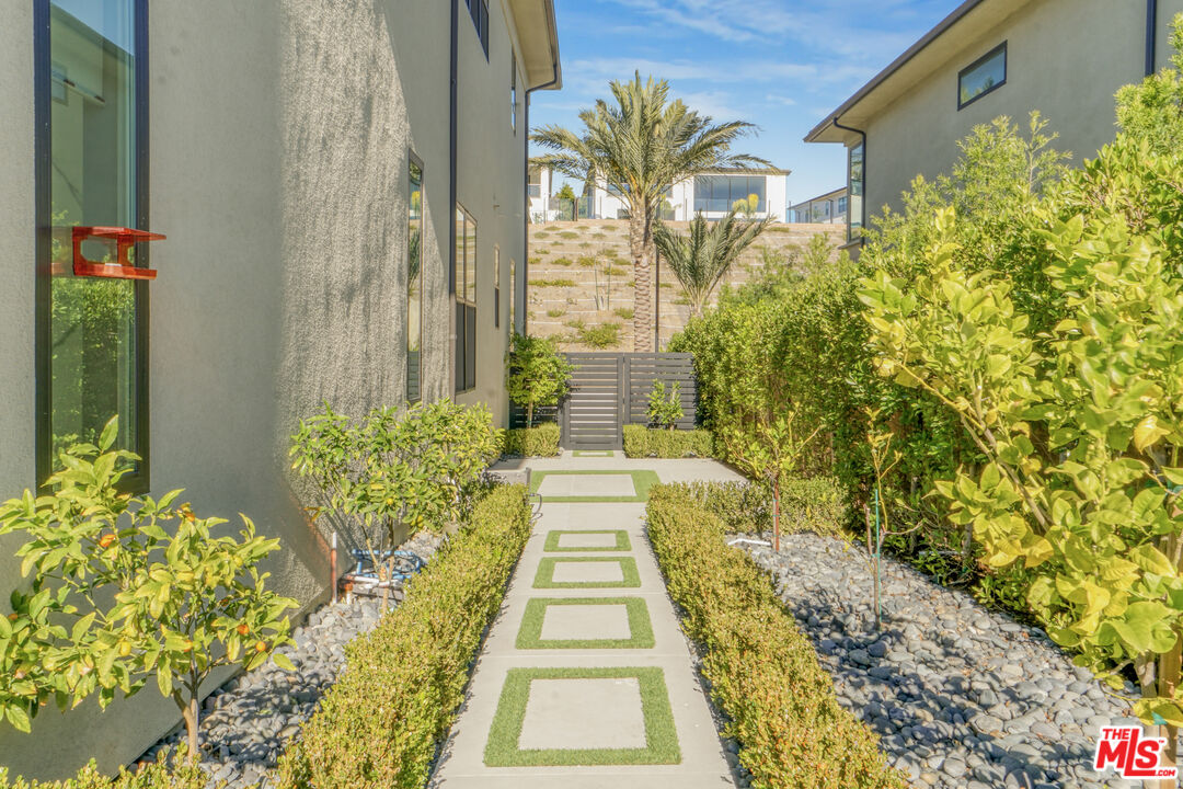 20306 Willoughby Lane Porter Ranch, CA 91326 - Photo 38 of 40 a view of a pathway both side of flower house