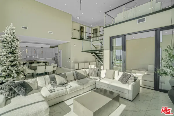 a living room with furniture and a chandelier