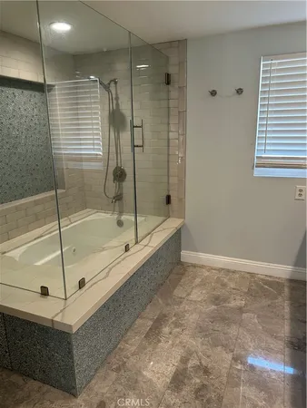 a bathroom with a shower and a bathtub