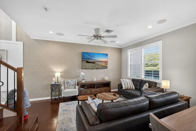 a living room with furniture and a chandelier