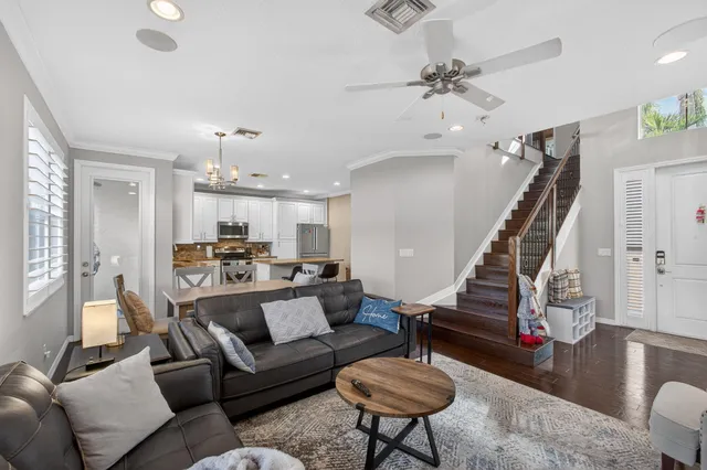 a living room with furniture stairs and a window