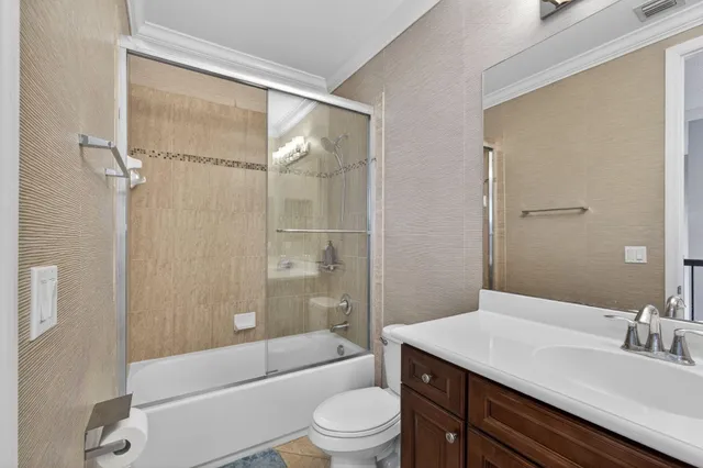 a bed sitting in a spacious bedroom next to a window