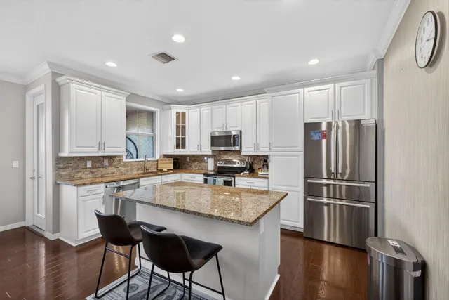 a kitchen with a refrigerator stove and sink