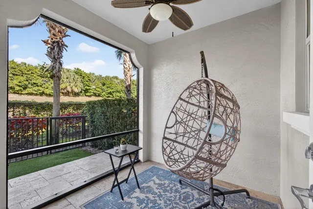 a view of a house with a yard and potted plants