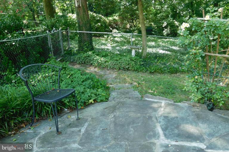 3 Crescent Road, Unit B Greenbelt, MD 20770 - Photo 17 of 22 a view of a yard with plants and a bench