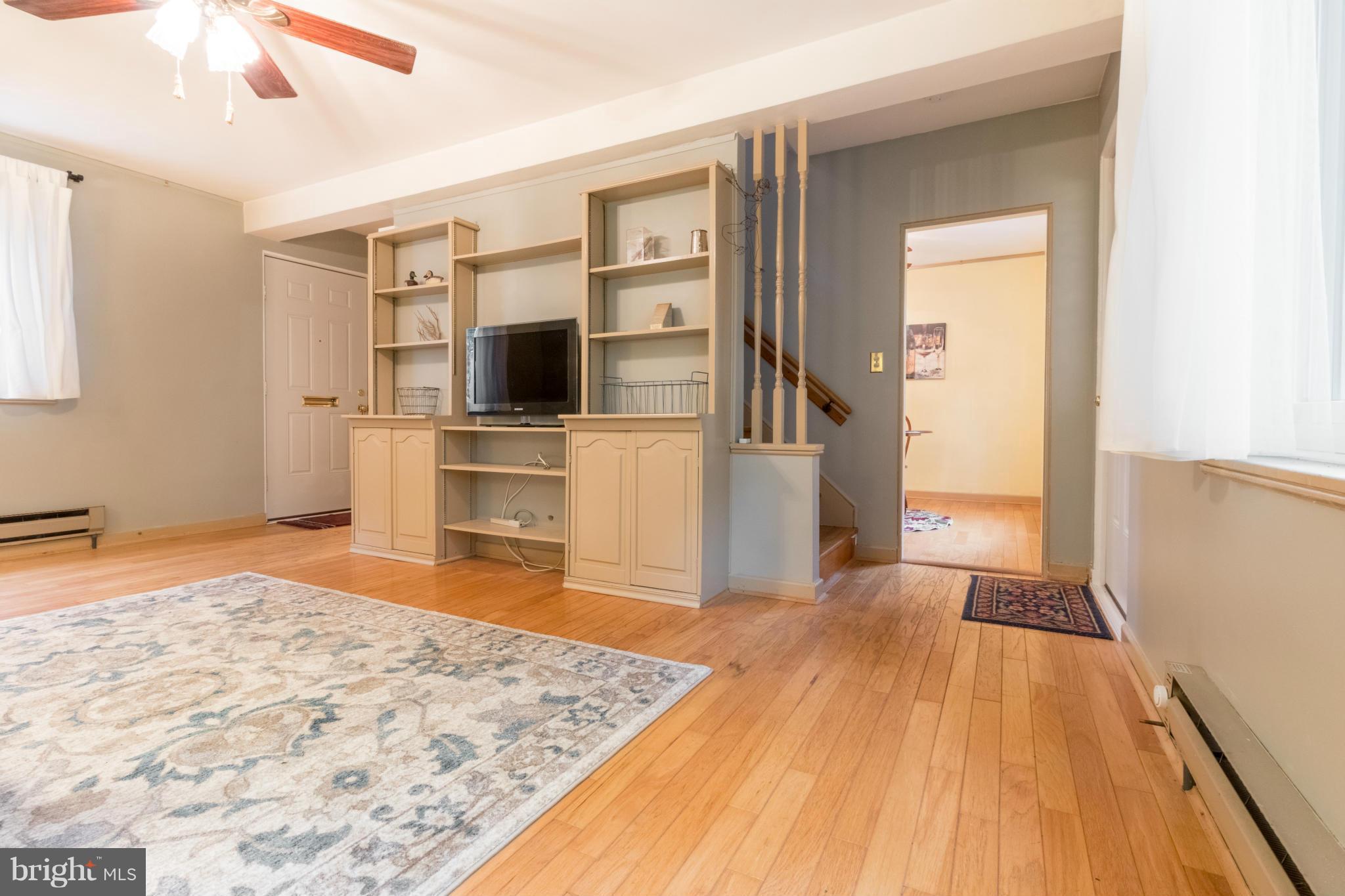 3 Crescent Road, Unit B Greenbelt, MD 20770 - Photo 4 of 22 a view of a livingroom with wooden floor and kitchen space