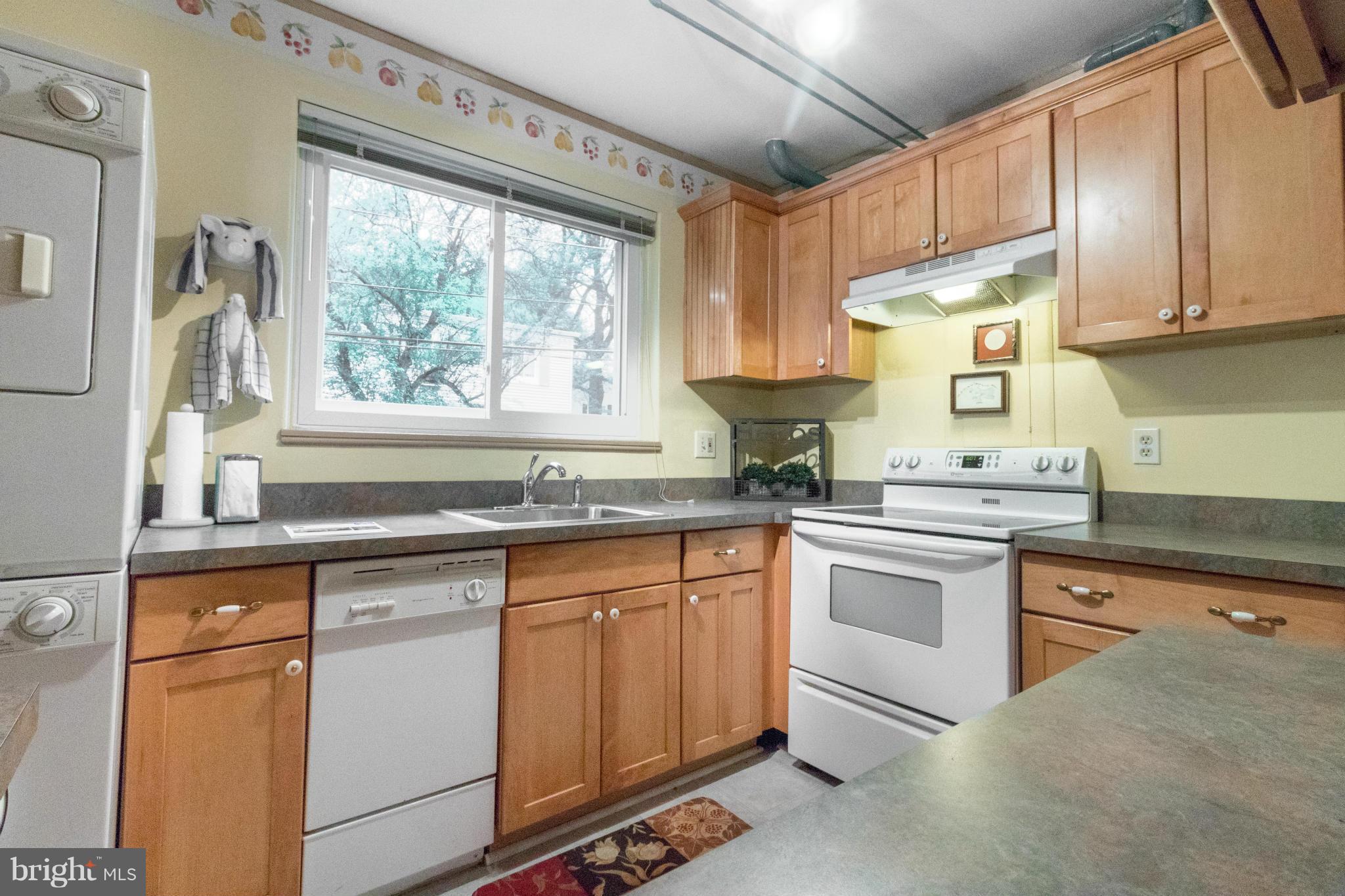3 Crescent Road, Unit B Greenbelt, MD 20770 - Photo 7 of 22 a kitchen with granite countertop white cabinets and white appliances